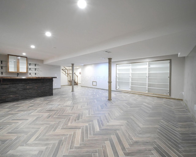 finished basement featuring bar, a sink, and recessed lighting