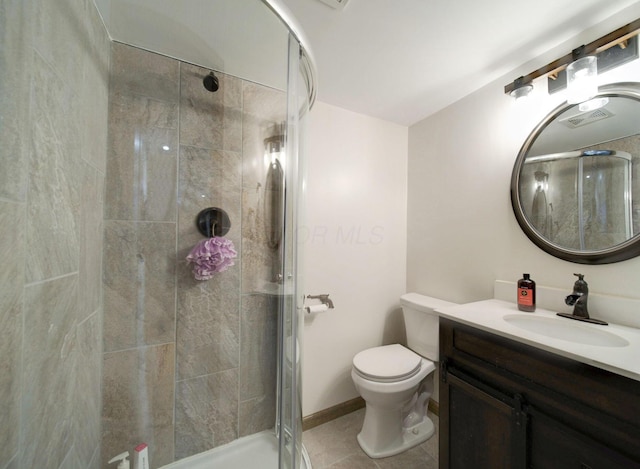 bathroom with visible vents, toilet, a stall shower, vanity, and tile patterned floors