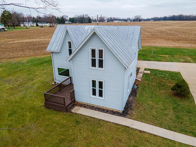 view of front of home featuring a front lawn and a rural view