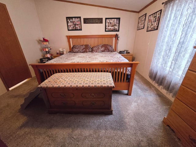 bedroom featuring dark carpet, lofted ceiling, and ornamental molding