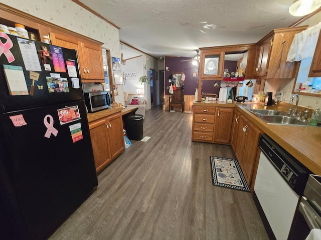 kitchen with white dishwasher, black fridge, sink, ceiling fan, and dark hardwood / wood-style flooring