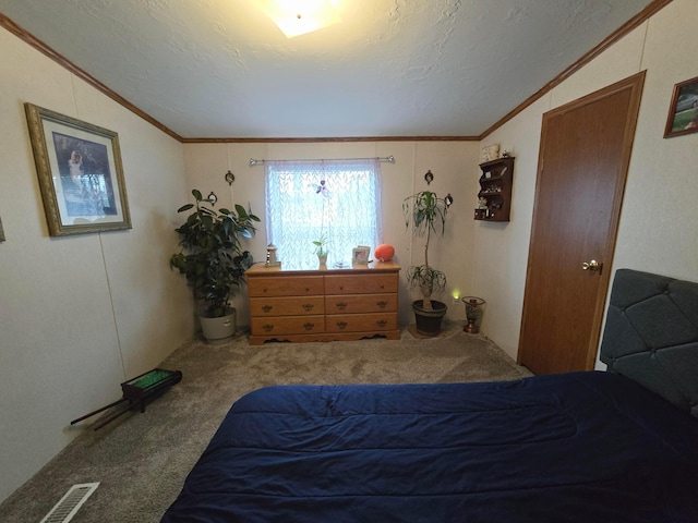 carpeted bedroom featuring crown molding, lofted ceiling, and a textured ceiling