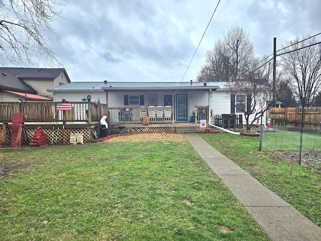 back of house featuring a yard and a deck