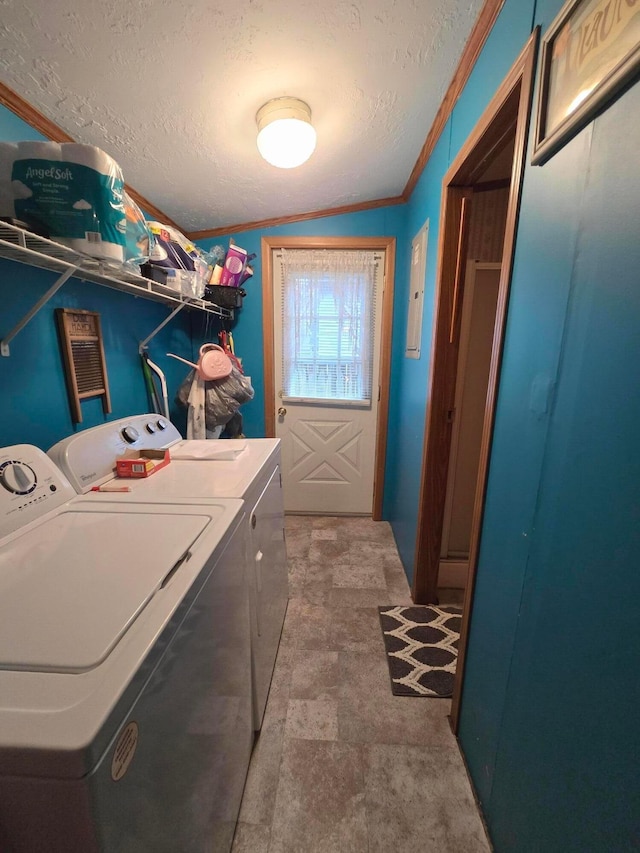 laundry area with ornamental molding, a textured ceiling, and washing machine and clothes dryer