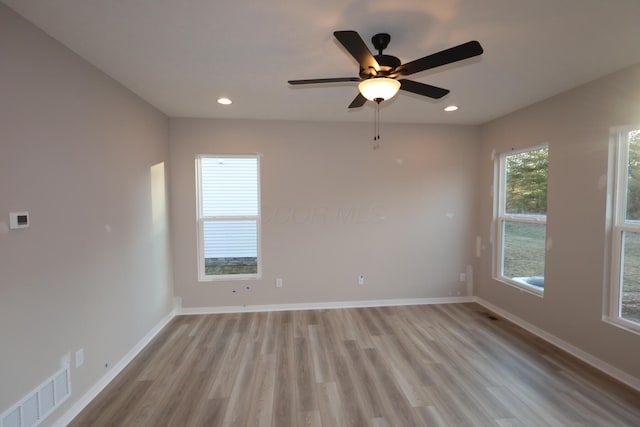 unfurnished room with recessed lighting, a ceiling fan, visible vents, baseboards, and light wood-type flooring