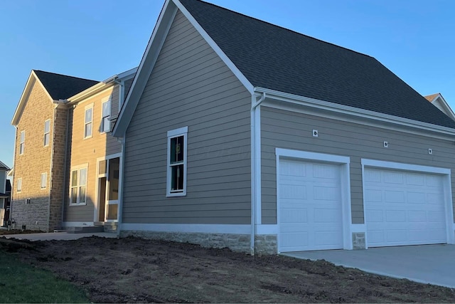 view of side of home featuring a garage