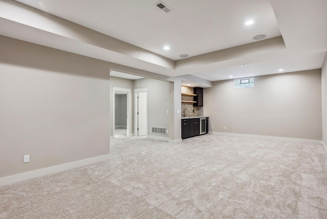 basement with carpet floors and indoor wet bar