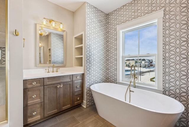 bathroom featuring a tub to relax in and vanity