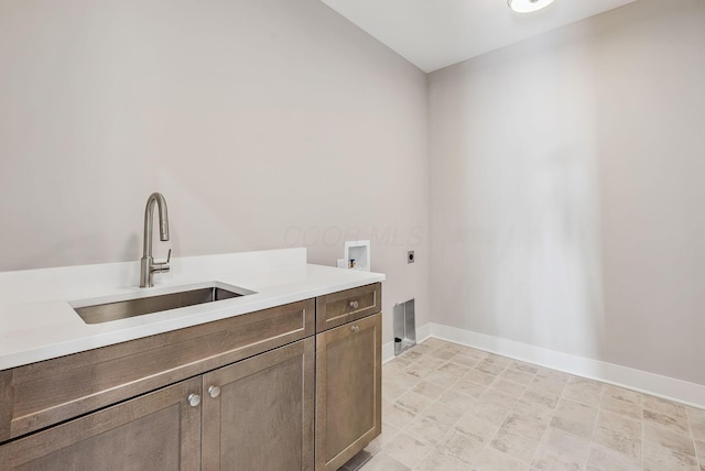 laundry area featuring cabinets, sink, hookup for a washing machine, and electric dryer hookup