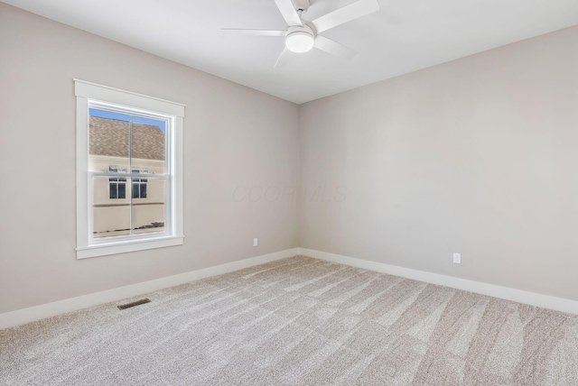 unfurnished room with carpet and ceiling fan