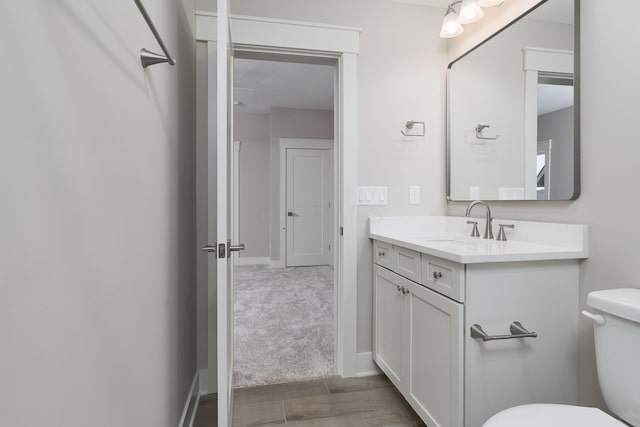 bathroom with toilet and vanity