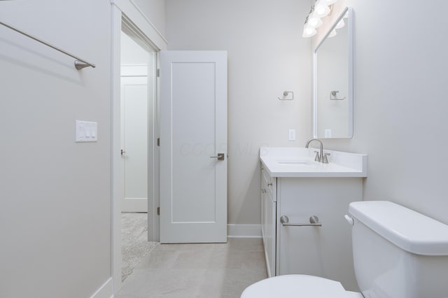 bathroom featuring toilet and vanity