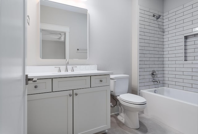 full bathroom with toilet, tiled shower / bath, and vanity