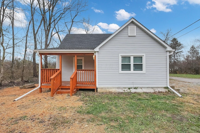 rear view of house featuring covered porch