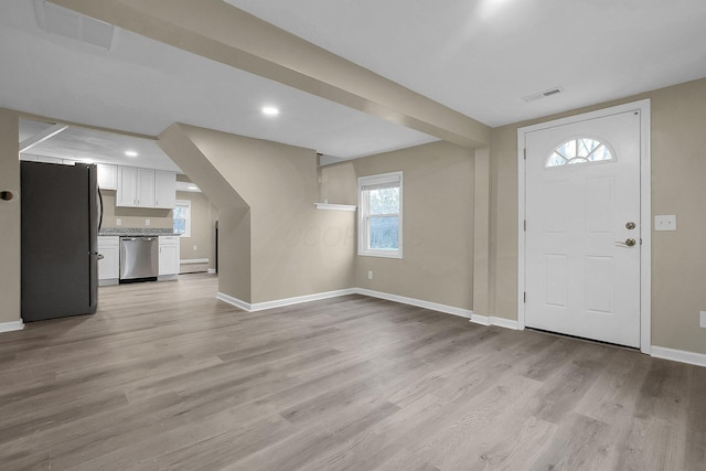 entryway with light hardwood / wood-style floors