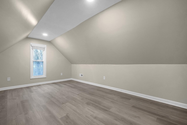 bonus room featuring light hardwood / wood-style floors and vaulted ceiling