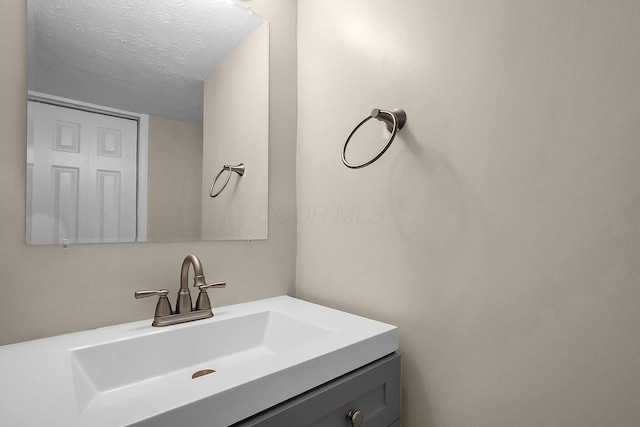 bathroom with vanity and a textured ceiling