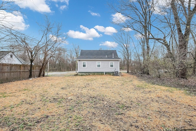 rear view of house featuring a lawn