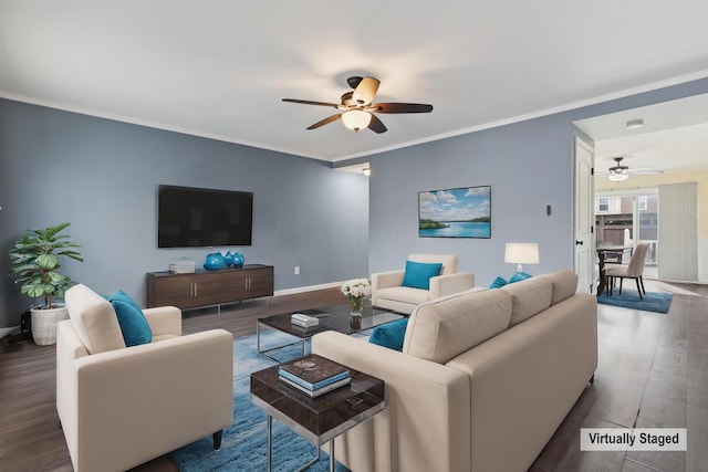 living room featuring a ceiling fan, baseboards, ornamental molding, and wood finished floors