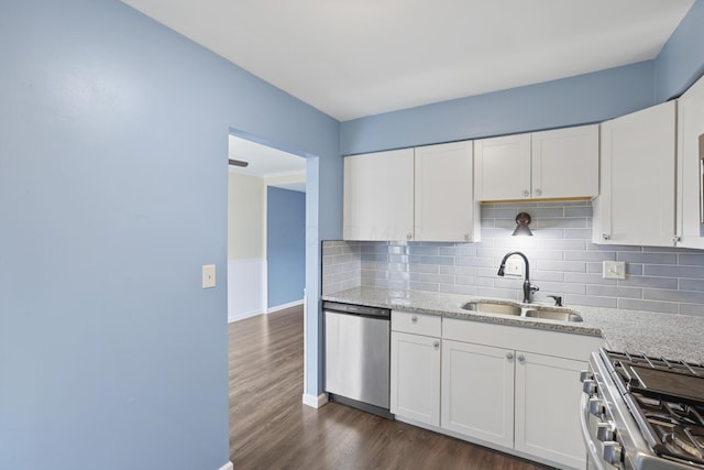 kitchen with stainless steel appliances, dark wood-style flooring, a sink, and white cabinetry