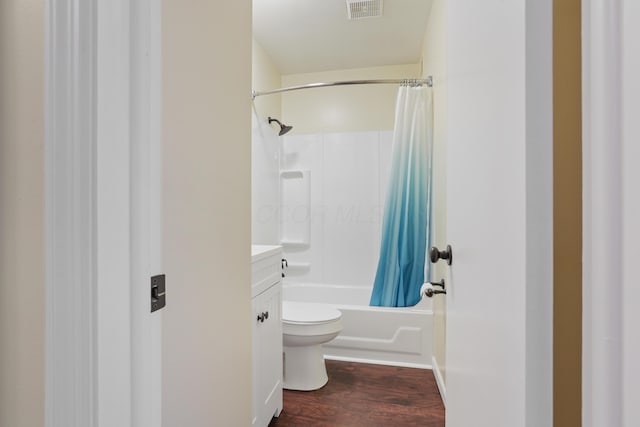 bathroom with visible vents, toilet, shower / bath combo with shower curtain, vanity, and wood finished floors