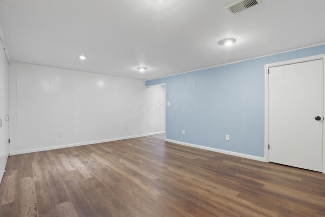 interior space with wood finished floors, visible vents, and baseboards