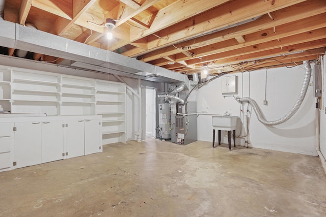 unfinished below grade area featuring water heater, a sink, and heating unit