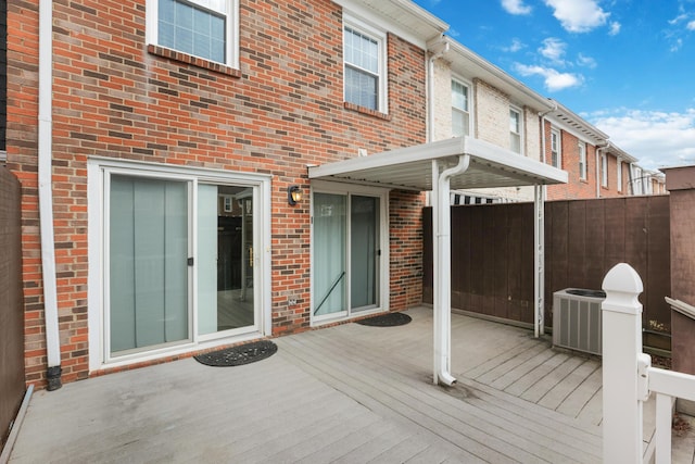 deck featuring central AC unit and fence