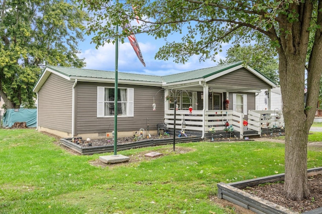 view of front of home with a front yard and a porch