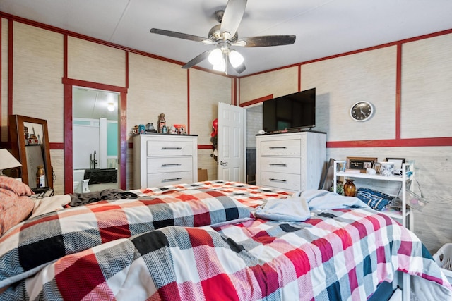 bedroom with ceiling fan and crown molding