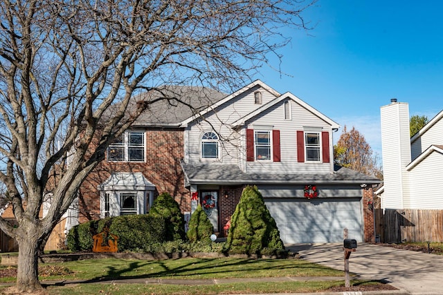 view of front of property with a garage and a front lawn