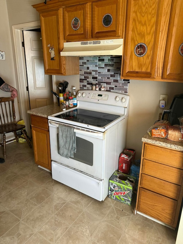 kitchen with tasteful backsplash and white range with electric cooktop