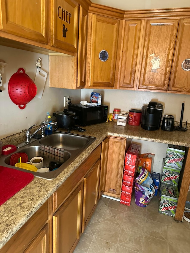 kitchen featuring light stone countertops and sink