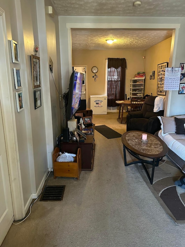 living room with a textured ceiling and carpet flooring