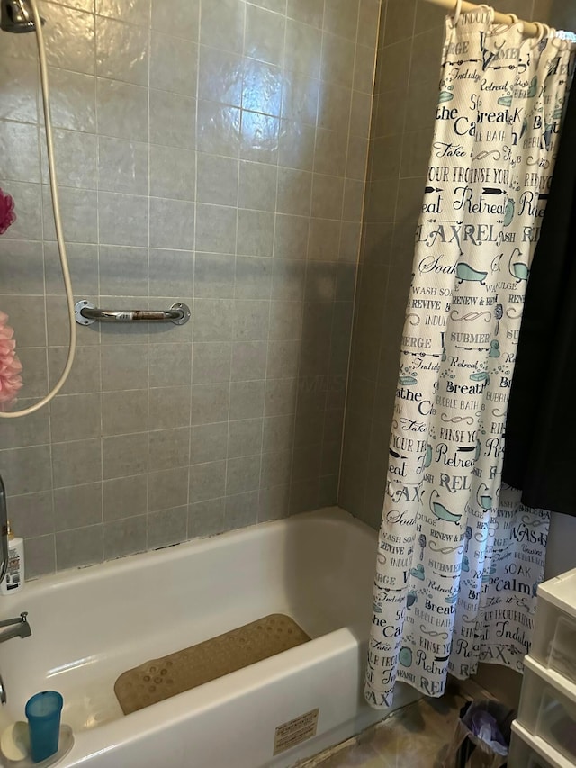 bathroom with shower / bath combo with shower curtain