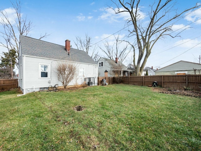 rear view of property with a yard