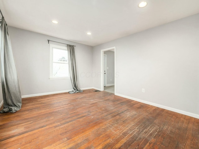 spare room with hardwood / wood-style flooring