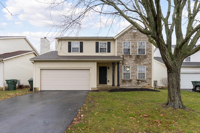 view of front facade featuring a front lawn and a garage