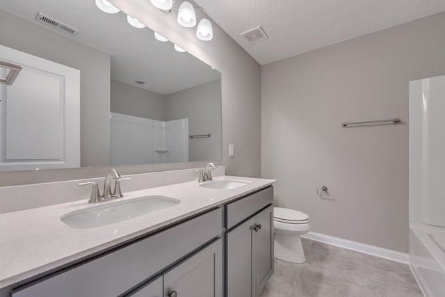 full bathroom with toilet, shower / bathing tub combination, tile patterned floors, a textured ceiling, and vanity