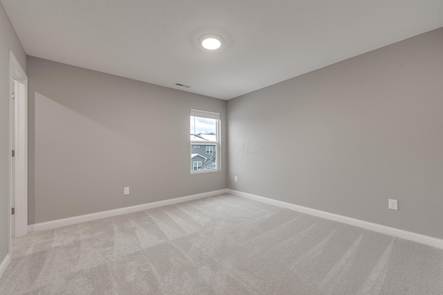 unfurnished room with light colored carpet