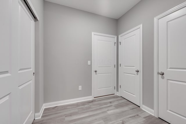 unfurnished bedroom with light wood-type flooring