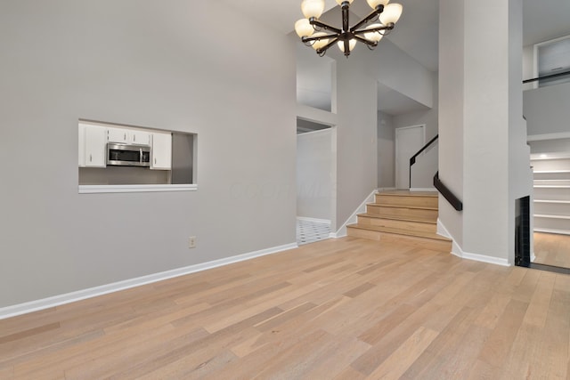 interior space with light hardwood / wood-style flooring and an inviting chandelier