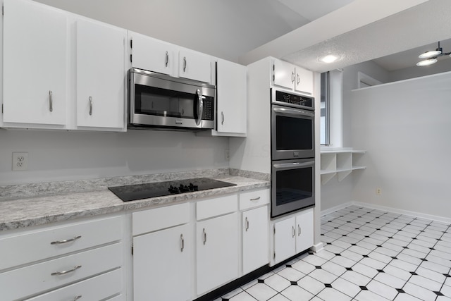 kitchen with white cabinets and appliances with stainless steel finishes