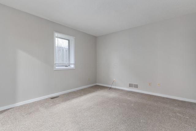 empty room featuring carpet floors