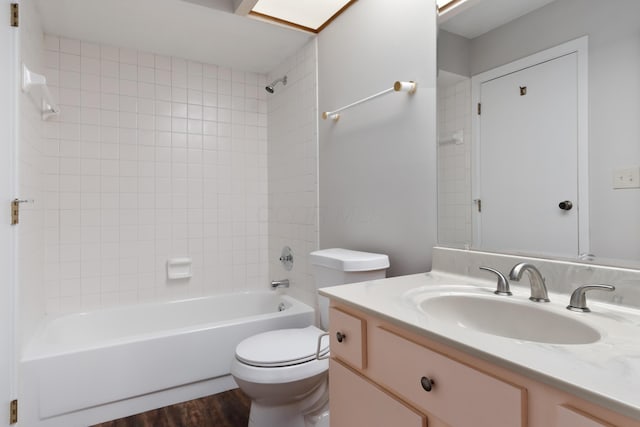 full bathroom featuring vanity, toilet, wood-type flooring, and tiled shower / bath