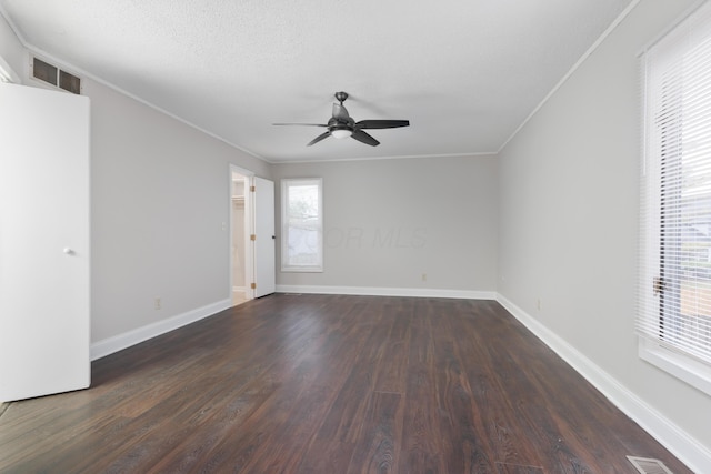 unfurnished room with crown molding, ceiling fan, and dark hardwood / wood-style floors