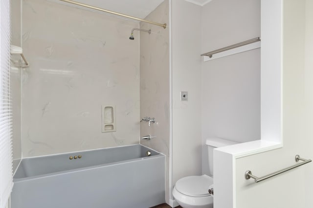 bathroom featuring bathtub / shower combination and toilet