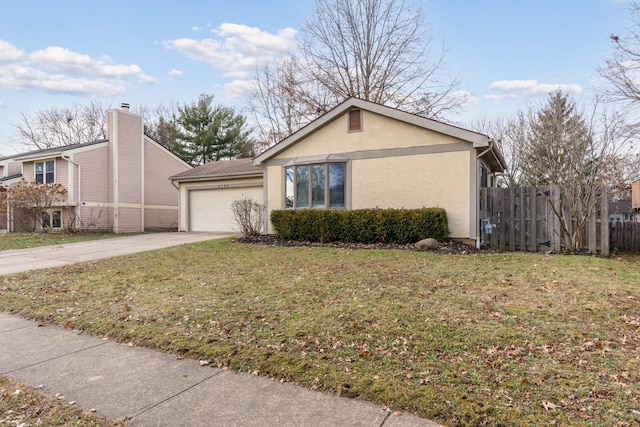 view of front of property with a garage and a front lawn