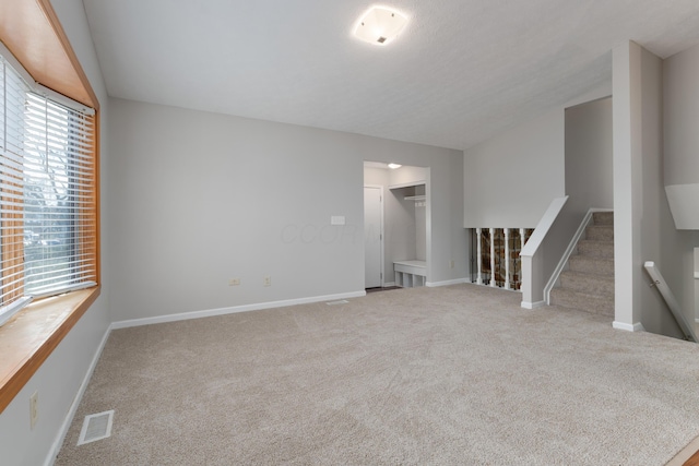 unfurnished living room featuring carpet floors