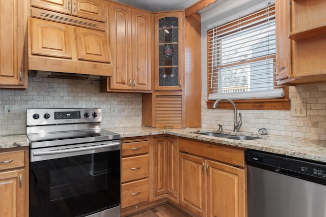 kitchen featuring custom exhaust hood, sink, decorative backsplash, light stone countertops, and stainless steel appliances